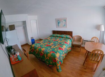 Single queen bed room interior at Sea Chest Motel Wildwood Crest