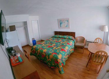 Single queen bed room interior at Sea Chest Motel Wildwood Crest